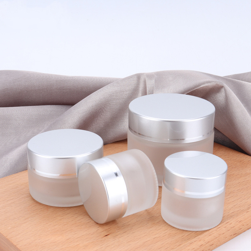 Custom frosted glass cream containers with silver lid
