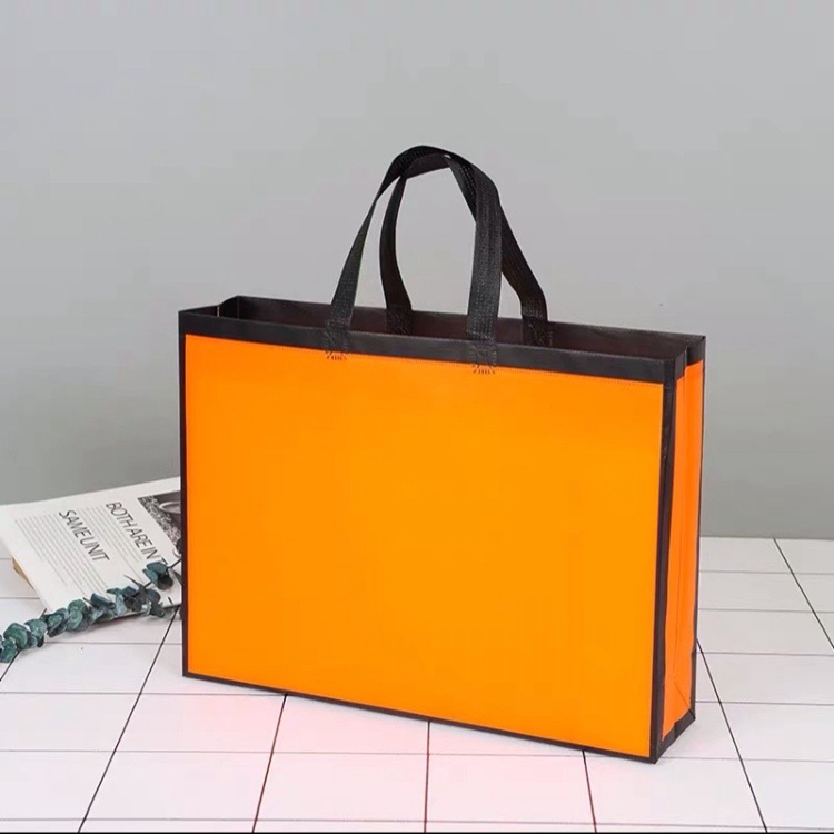 Custom orange portable non woven shopping gift bags packaging with logo for clothing
